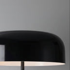Black dome lamp shade on tripod table lamp