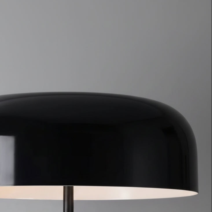 Black dome lamp shade on tripod table lamp