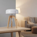 Tripod table lamp with white dome shade and light wood tripod legs