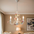 Floral arm chandelier with white scroll arms, pink rose accents, and three candle bulbs