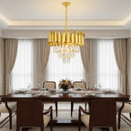 Gold round chandelier with crystal drops and slim cylinder shade accents