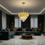 Gold chandelier with crystal drop fringe and modern drum shades over a sofa