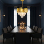 Gold drum-style chandelier with crystal drops hanging over a dining table