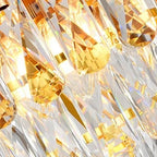 Close-up of sparkling clear crystal drops and gold-toned metal details
