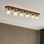 Rectangular flush mount ceiling light with 6 clear glass bulbs on dark metal plate