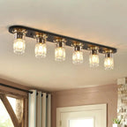 Linear flush mount ceiling light with black bar and five clear glass bulb shades