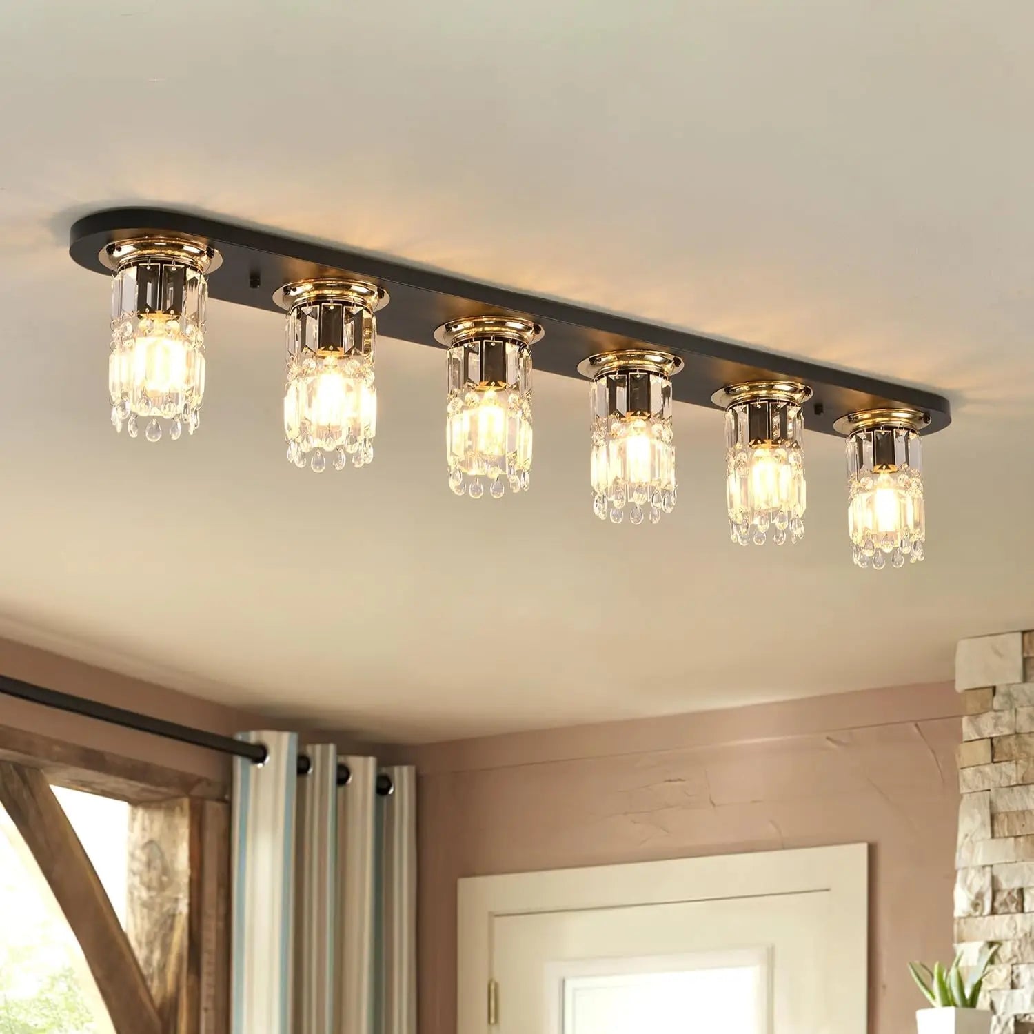 Linear flush mount ceiling light with black bar and five clear glass bulb shades
