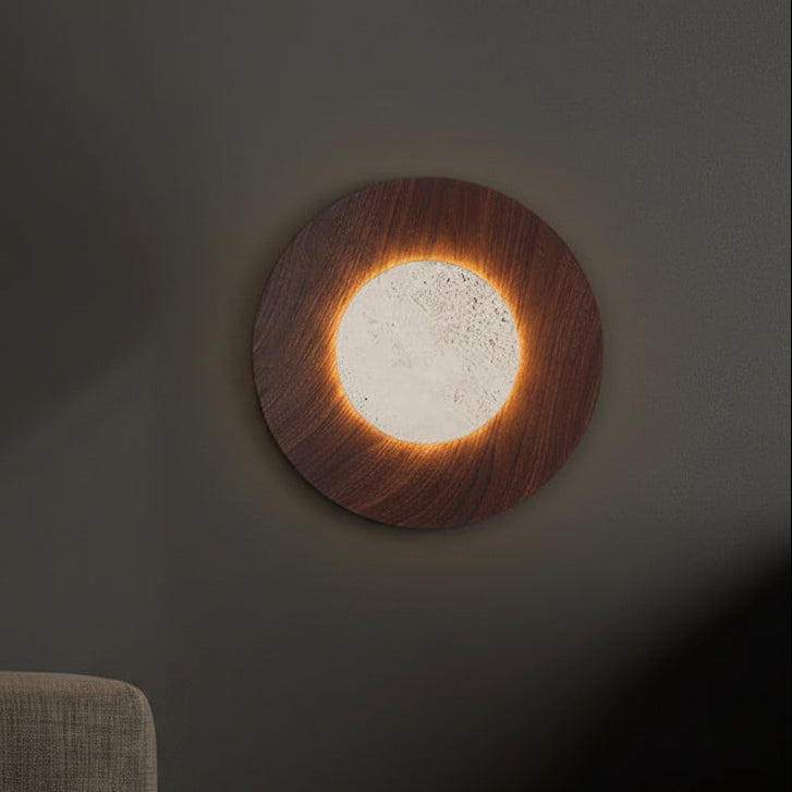 Brown round wall light sconce with glowing inner travertine panel and soft warm halo