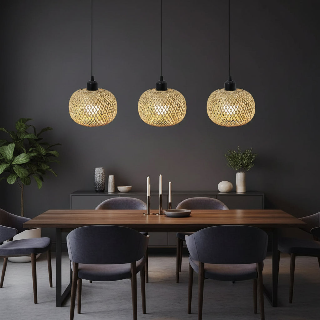 Three woven rattan globe pendant lights glowing warmly with black cords