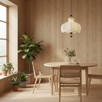 Cream scalloped pendant light with brown wooden ball accents in a bright dining area