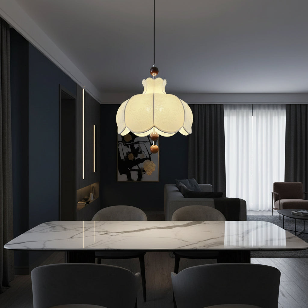 Cream scalloped fabric pendant light with brown wooden balls above living room seating