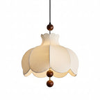 Scalloped cream fabric pendant lamp with brown bead details and black hanging cord