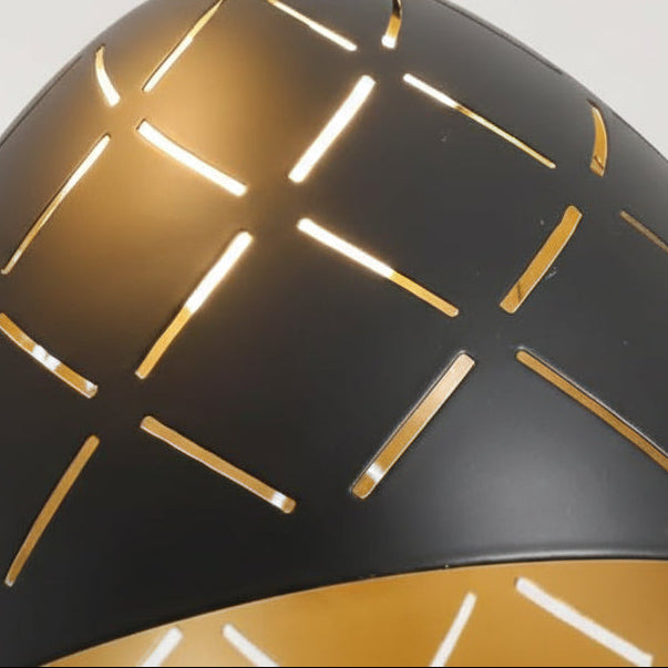Close-up of black conical shade with gold linear cutouts on spiral chandelier