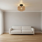 Woven rattan drum flush mount ceiling light centered above living room