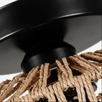 Black flush mount base with woven rattan cords attached to drum light shade