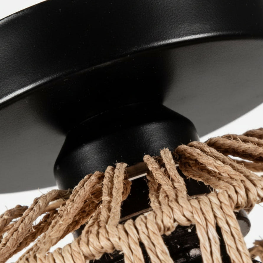 Black flush mount base with woven rattan cords attached to drum light shade