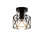Geometric cage flush-mount ceiling light in black with gold accents and glass bulb