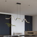 Wavy linear LED pendant light hanging in an asymmetrical flow with dark canopy