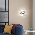 Spiral ribbon LED wall sconce with polished metal spiral shape and small rectangular mount