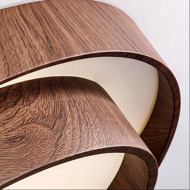 Close-up of dual-ring ceiling light: woodgrain brown rings with white inner diffuser