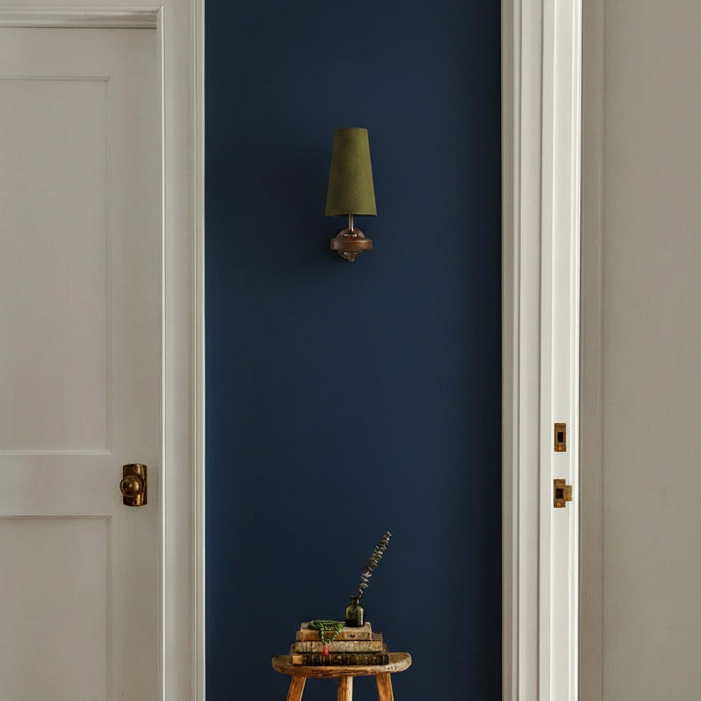 Green fabric cone wall sconce with bronze mounting plate and single shade