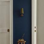 Green fabric cone wall sconce with bronze mounting plate and single shade