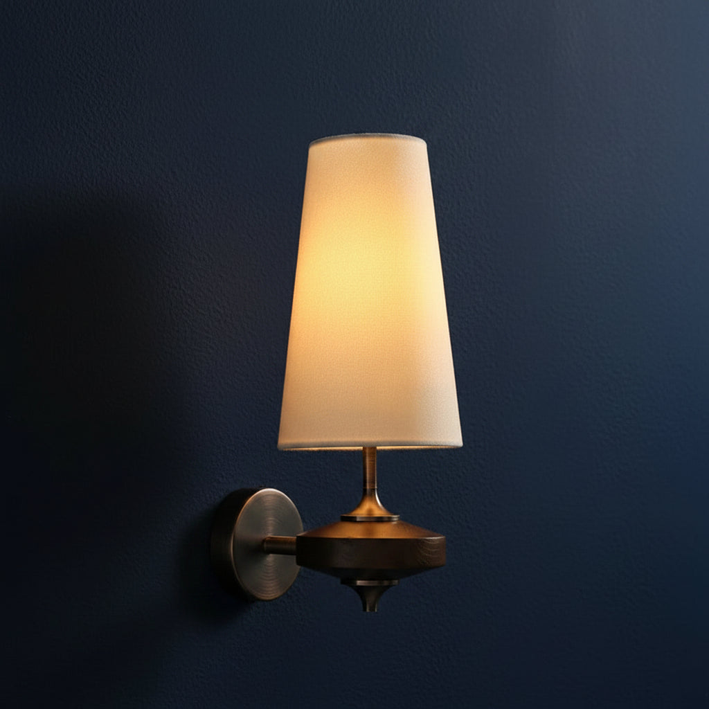 Off-white fabric cone wall sconce with bronze backplate and single lamp shade