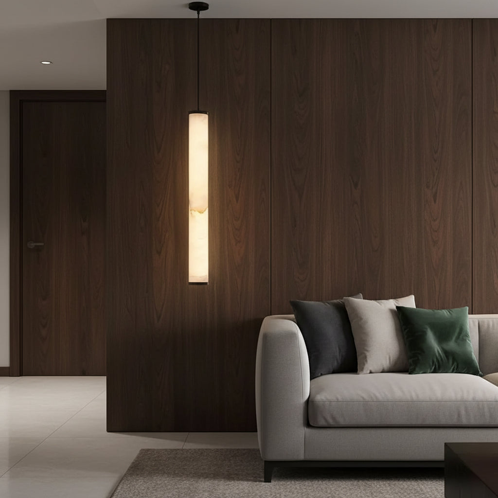 Minimalist tubular pendant light with cream alabaster shade, black cord and cap.