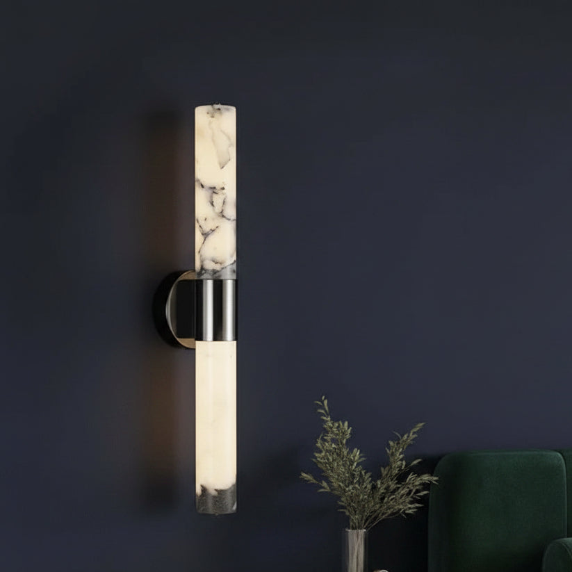 Cylindrical alabaster tube wall sconce with stainless steel mounting bar and dark backplate