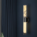 Modern cylindrical wall sconce with glowing alabaster diffuser and black wall mount