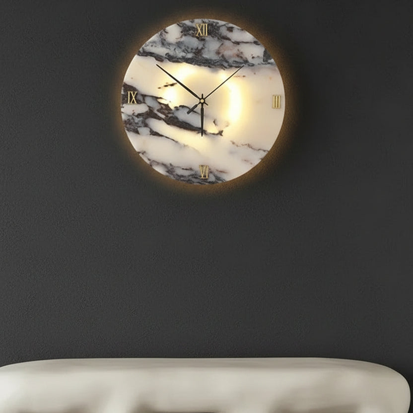 Round backlit marble wall clock light with Roman numerals and black hands on dark wall