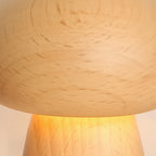 Close-up of light wood mushroom lamp shade with visible grain texture