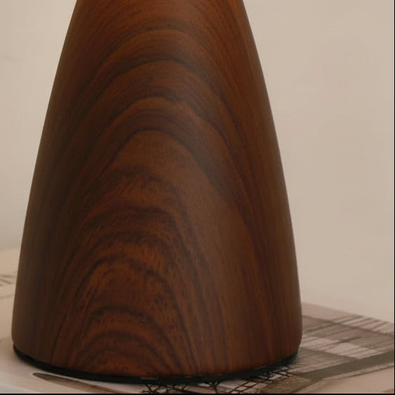 Close-up of dark wood-grain ceramic lamp base with tapered conical shape