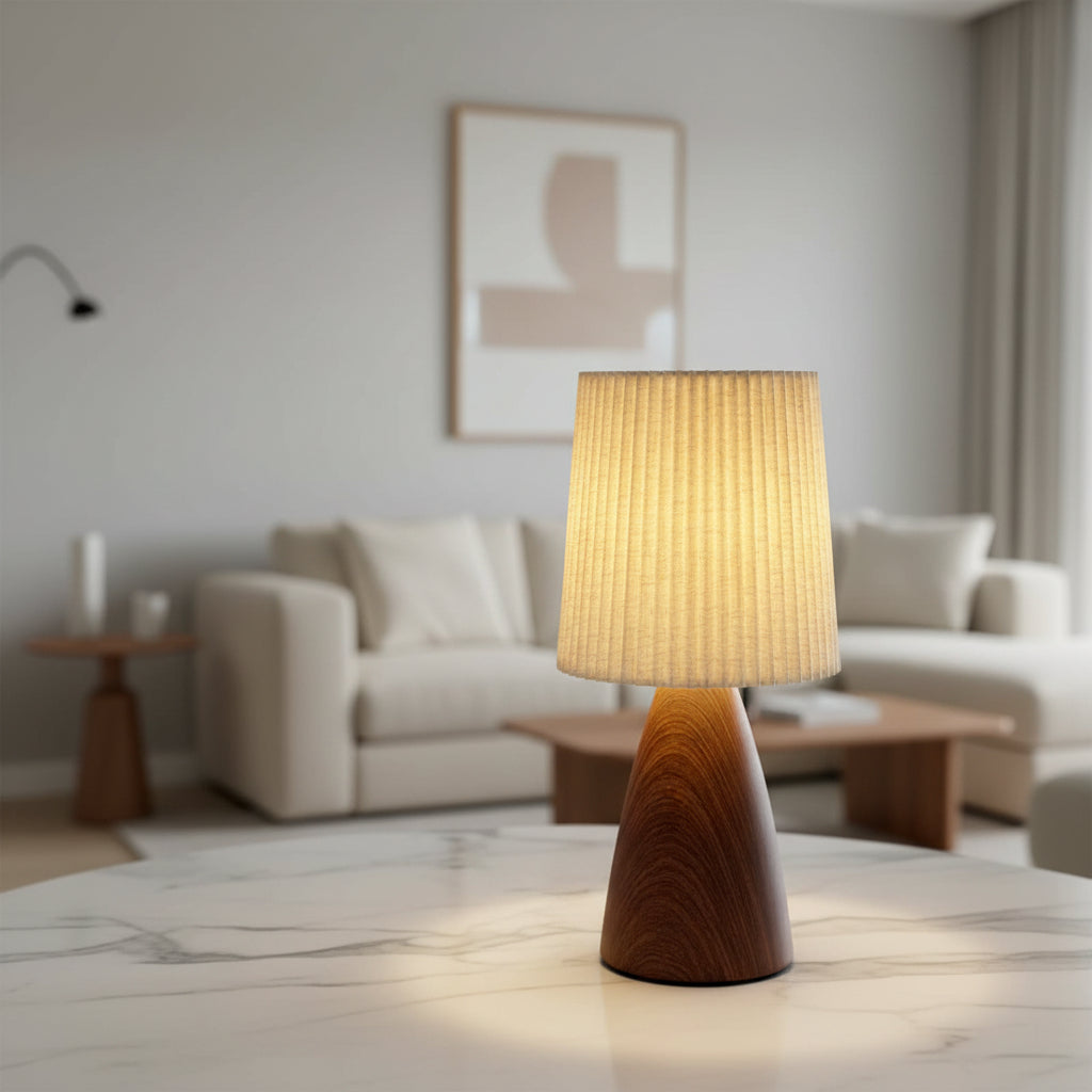 Conical desk lamp with pleated beige shade and dark walnut-toned ceramic base
