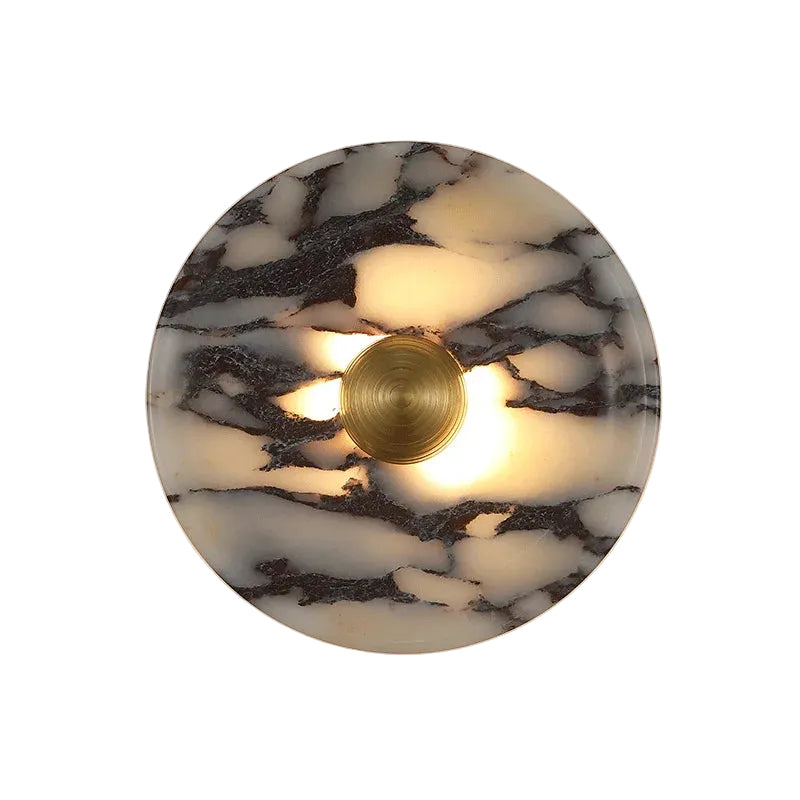 Round marble wall sconce with backlit glow and gold central ring
