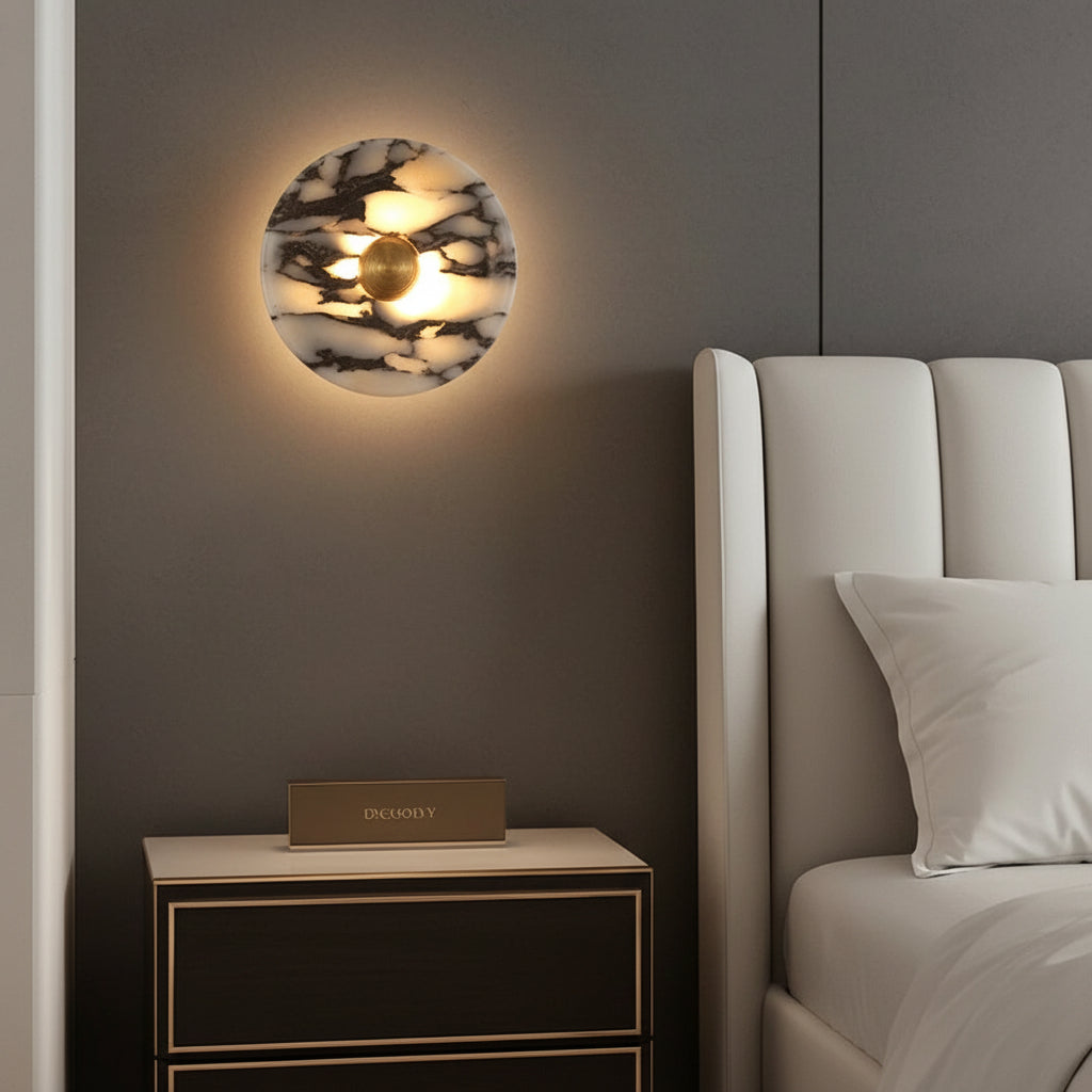 Round marble wall sconce with warm backlight and gold center