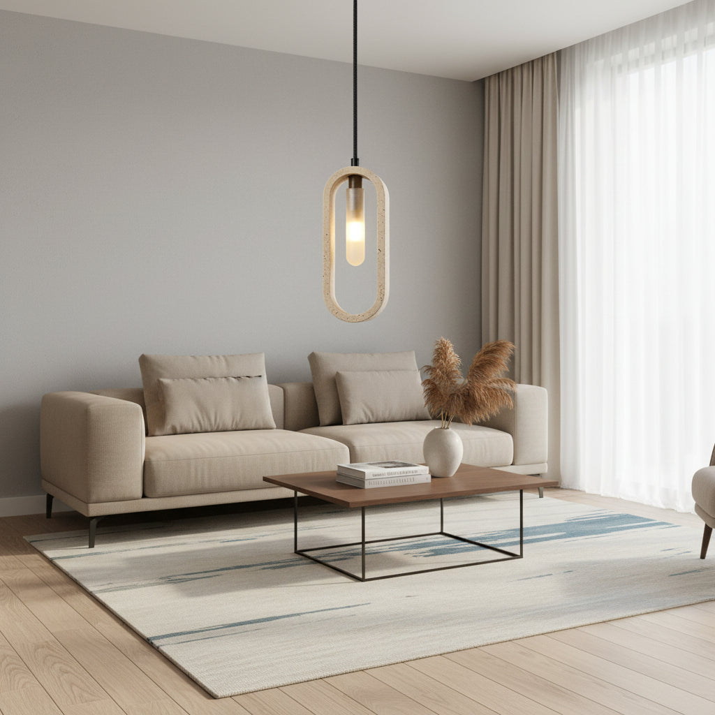 Oval travertine pendant light with clear bulb glow and black cord, hanging indoors