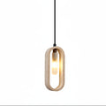 Hanging oval travertine pendant light with warm bulb glow and black power cord