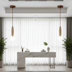 Two hanging globe pendant lights with travertine cylinder shades over dining bar