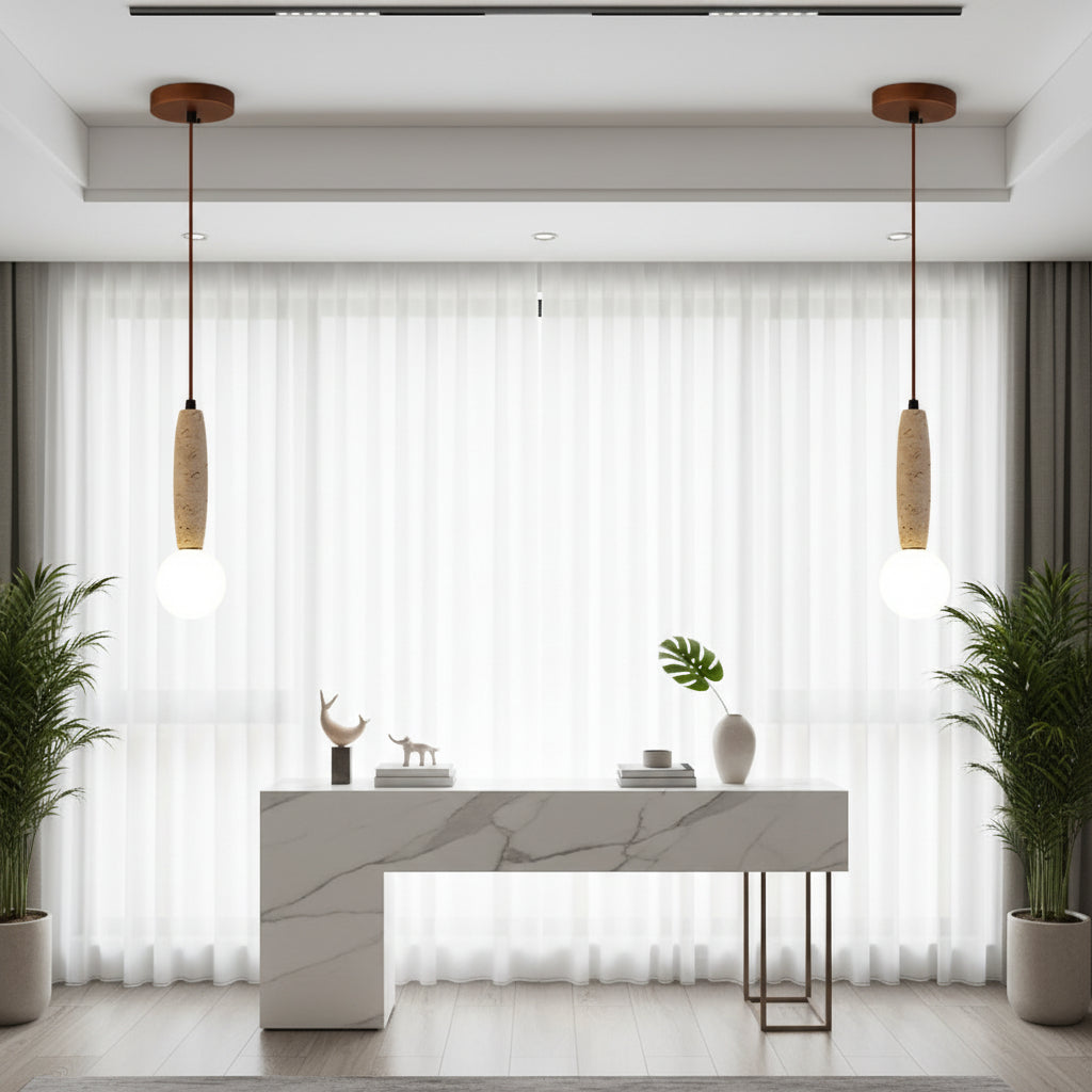 Two hanging globe pendant lights with travertine cylinder shades over dining bar