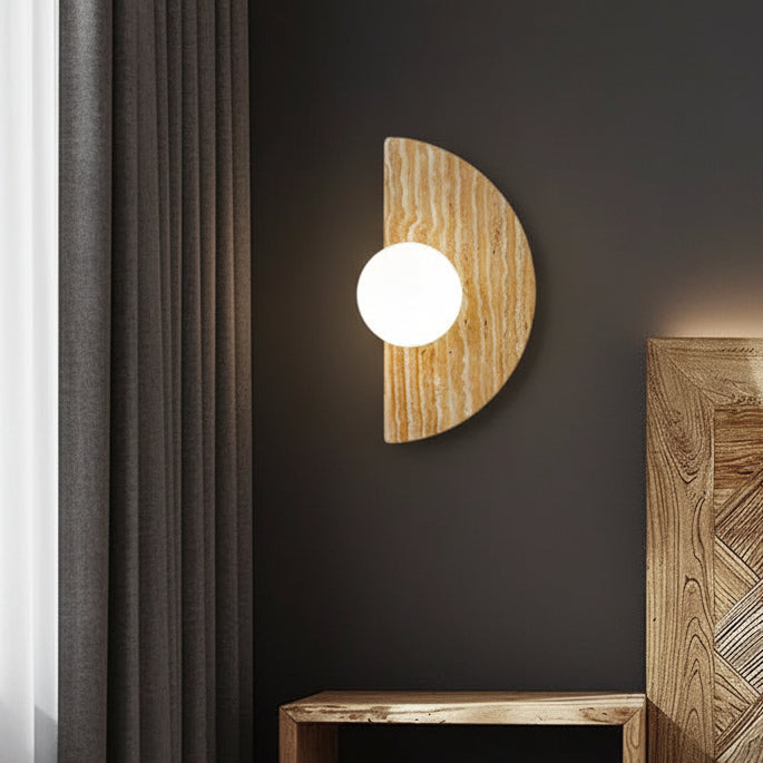 Travertine half-moon wall sconce with round white globe diffuser, mounted
