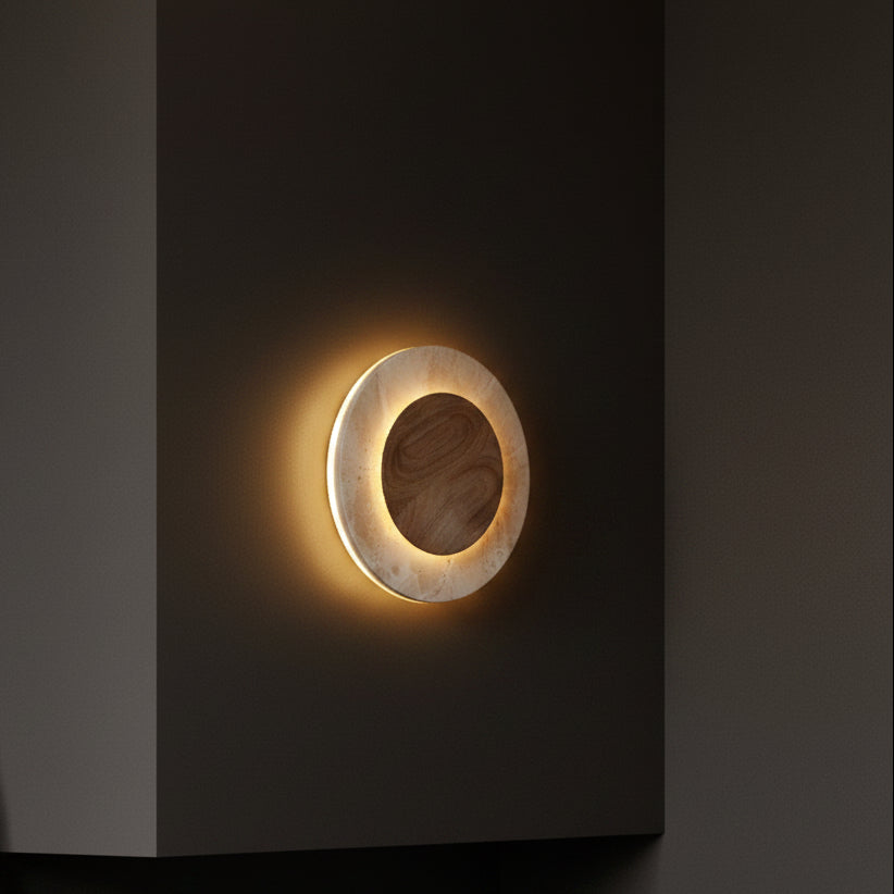 Round backlit wall sconce with glowing oval ring and wood-tone inner disc