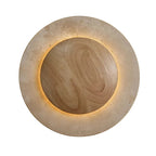 Round backlit wall sconce with travertine outer ring and wood-tone center disc