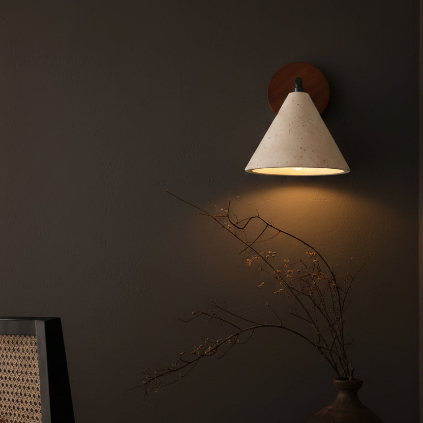 Wall sconce with conical speckled shade, black bar, round wood mount, warm glow