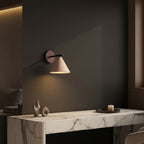 Conical wall sconce with round wood mount and black arm, illuminated speckled shade