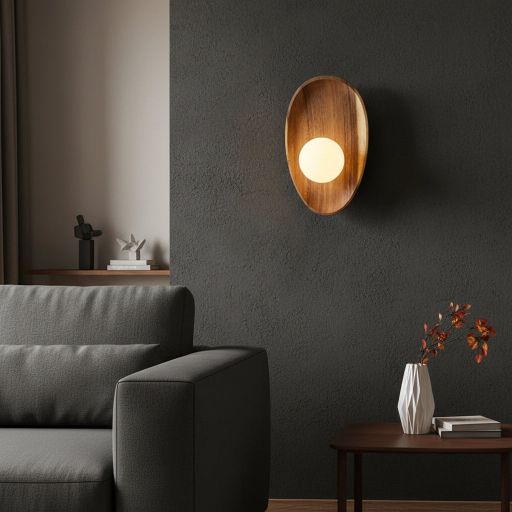 Wood oval backplate wall sconce with glowing round bulb