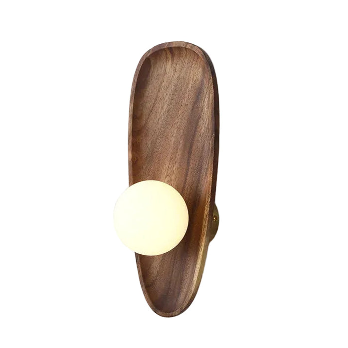 Oval wall sconce with round white globe and wood backplate, side view