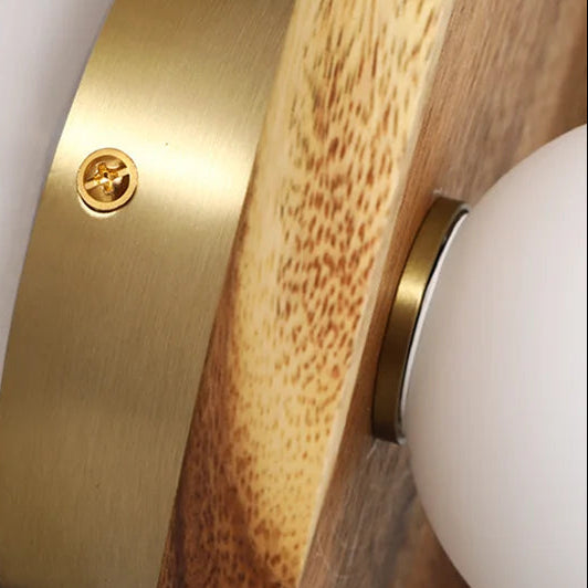Wood sconce backplate detail with brass screw and mounting socket