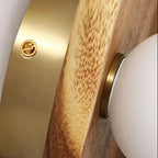 Wood sconce backplate detail with brass screw and mounting socket
