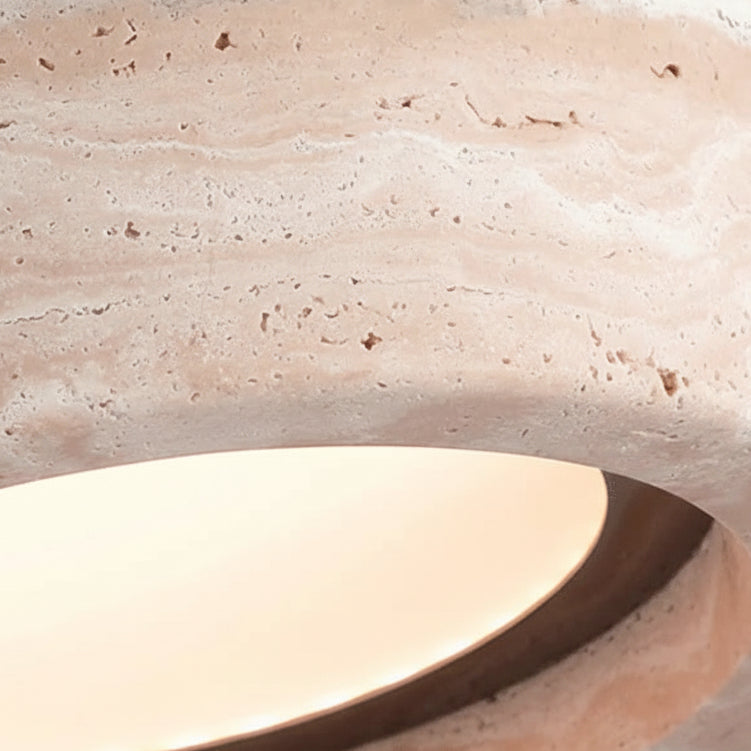 Travertine pendant shade close-up with warm lit inner rim